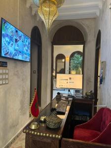 an office with a desk with a computer and a chair at Riad M'Barka in Tangier