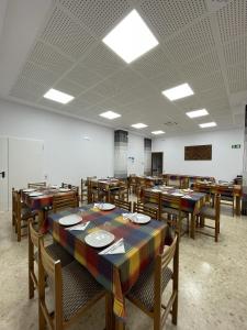 an empty classroom with wooden tables and chairs at Albergue Rosa Molas in Arrabal de Jesús