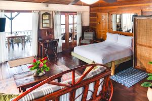 a bedroom with a bed and a living room at Casa Acuario Boutique Hotel in Bocas Town