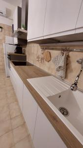 a kitchen with a sink in the middle of it at Appartamento in campagna vicino autostrada Campogalliano - Carpi in Campogalliano +33 photos