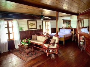 a bedroom with a bed and a table and chairs at Casa Acuario Boutique Hotel in Bocas Town +188 photos