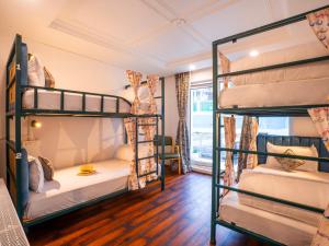 a dorm room with four bunk beds in it at Moustache Pahalgam in Pahalgām