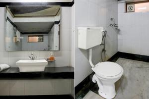 a bathroom with a white toilet and a sink at Super Collection O Rai Ka Bagh Near Railway Station Formerly Pioneer Plaza in Jodhpur