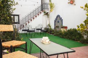 a patio with a table and chairs and stairs at Hostel Pituco - En el corazón de la ciudad in Mendoza