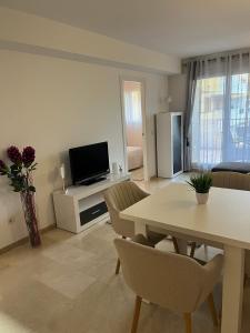 a living room with a table and a television at CC8 VI by ZANIS in Torrevieja