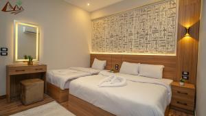 Ένα ή περισσότερα κρεβάτια σε δωμάτιο στο Suzana Pyramids hotel