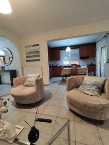 a living room with two chairs and a table at SOLMAR HOUSE in Flogita