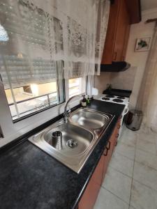 a kitchen with a sink and a window at SOLMAR HOUSE in Flogita +37 photos