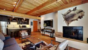 a living room with a couch and a fireplace at Timberline Condominiums 1 Bedroom Premier Unit D2F in Snowmass Village