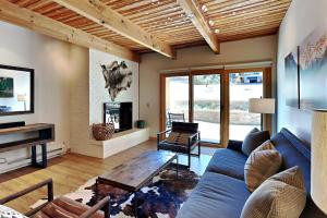 a living room with a blue couch and a fireplace at Timberline Condominiums 1 Bedroom Premier Unit D2F in Snowmass Village