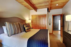 a bedroom with a large bed and a wooden ceiling at Timberline Condominiums 1 Bedroom Premier Unit D2F in Snowmass Village +17 photos