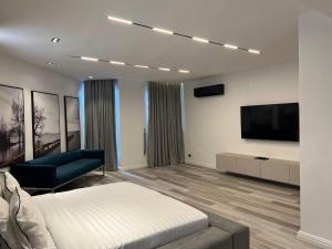 a bedroom with a bed and a flat screen tv at Luxury 3 bedroom apartment with swimming pool Ikoyi in Ikoyi