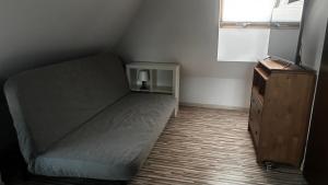 a small bedroom with a bed and a dresser at Norwida 28 - 300m od plaży in Olecko