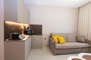 a kitchen with a couch and a chair in a room at Acropoleos Suites in Thessaloniki