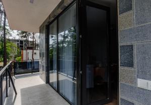 a glass door on the side of a building at BaBu shekvetili in Shekhvetili