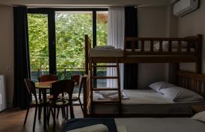 a room with two bunk beds and a table and chairs at BaBu shekvetili in Shekhvetili