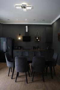 a dining room with a black table and chairs at dili hill in Dilijan
