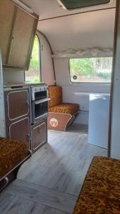 an interior view of an rv with a kitchen and couch at Alex's overnight in Heidelberg