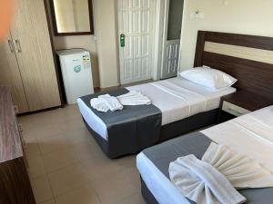 A bed or beds in a room at Rosella Hotel