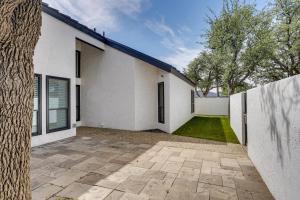 a white house with a fence and a yard at Outdoor Entertainment Area Spacious Midland Home! in Midland