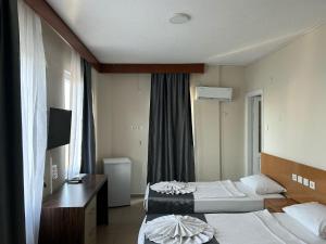 A bed or beds in a room at Rosella Hotel