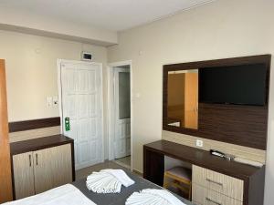 A bed or beds in a room at Rosella Hotel