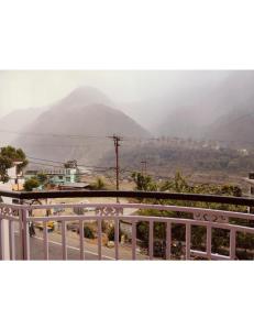 a view of a mountain from a balcony at Hotel Nagraja Palace होटल नागराजा पैलेस in Maneri