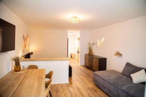 a living room with a table and a couch at Glückspfennig in Prien am Chiemsee