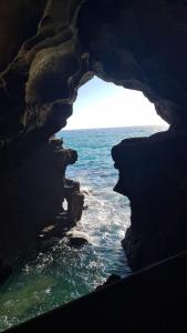 a view of the ocean from inside a cave at Appartement sur la corniche 2 chambres in Tangier