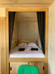 a bed with two black bags on top of it at Lechappee des causses in Mostuéjouls +25 photos