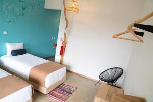 Postel nebo postele na pokoji v ubytování Hotel con Corazon Monteverde