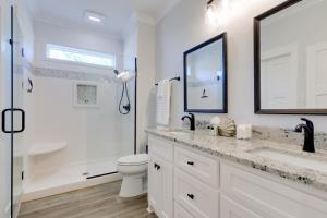 a white bathroom with a sink and a toilet at Luxe Family Condo with Gulf View in Dauphin Island! in Dauphin Island +23 photos