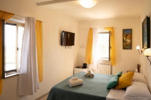 a bedroom with a bed with two towels on it at Chiaraluce Country House in Massignano