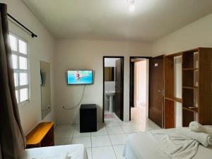 TV a/nebo společenská místnost v ubytování Casa Temporada Suítes