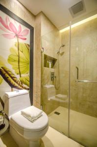 a bathroom with a toilet and a shower at Boracay Haven Suites in Boracay