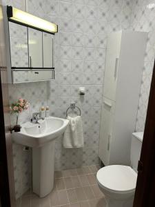a bathroom with a sink and a toilet at Apartamento Somo Mouro in Somo +10 photos