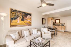 a living room with a couch and a painting on the wall at Granada II Apartments in Puerto Rico de Gran Canaria