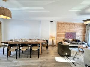 a dining room with a table and a couch at Chalet N°5 - CHALET PRESTIGE 9 P. PROCHE PISTES-Tout inclus MAE-4253 in Vars +22 photos