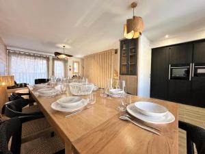 a large wooden table with plates and glasses on it at Chalet N°5 - CHALET PRESTIGE 9 P. PROCHE PISTES-Tout inclus MAE-4253 in Vars