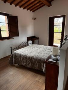 Postel nebo postele na pokoji v ubytování Agriturismo Quercetelli