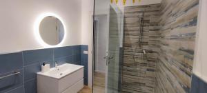 a bathroom with a sink and a glass shower at La Luna sul Conero in Casa Petromilli +5 photos