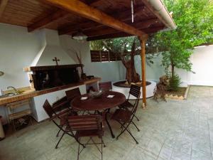 a patio with a table and chairs and a sink at Stylish 2BR Semi-Basement- Cozy & Family-Friendly Retreat in Loutraki