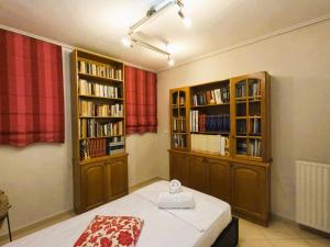 a room with two bookshelves and a bed in it at Stylish 2BR Semi-Basement- Cozy & Family-Friendly Retreat in Loutraki