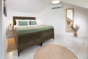 a bedroom with a large bed and a mirror at Villa Olea Lux Bol in Bol +20 photos