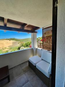 a balcony with a couch and a view of the desert at Sabbiamare Relax e Mare in Torre Dei Corsari