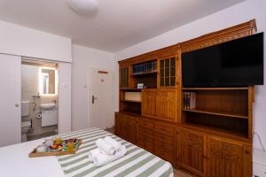 a bedroom with a large entertainment center with a flat screen tv at APARTMENT LEA BAYVIEW in Dubrovnik