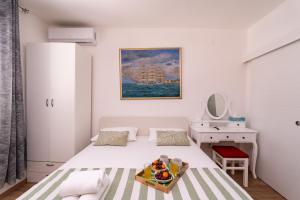 a small bedroom with a bed and a desk at APARTMENT LEA BAYVIEW in Dubrovnik