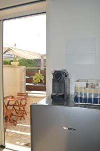 a kitchen with a microwave on top of a refrigerator at Camere A Oriente II in Torre dell'Orso