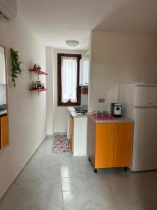 a kitchen with an orange counter and a refrigerator at Villette Isabella in Parghelia +59 photos