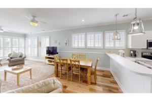 a kitchen and living room with a table and chairs at Litchfield Beach Retreat Lakeside Villa Serenity in Pawleys Island
